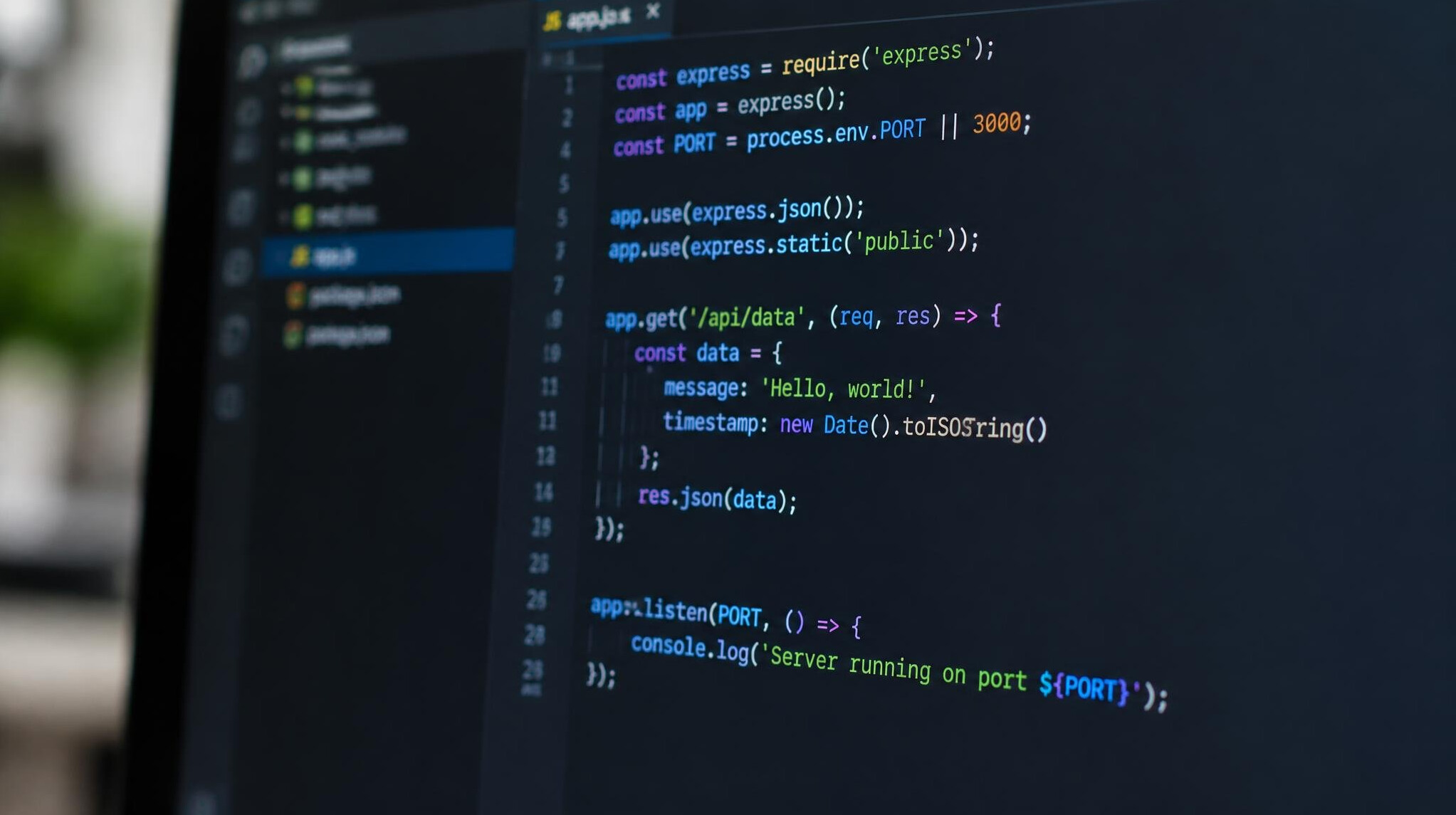 Close-up of a monitor displaying programming code in a text editor