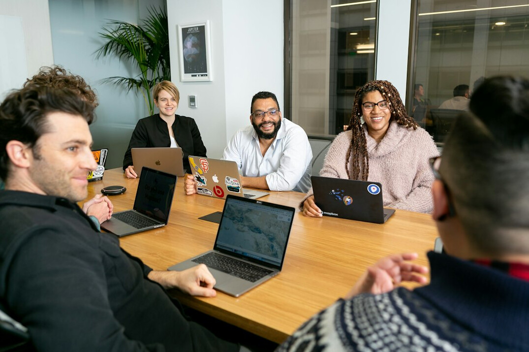 team meeting on insurance tech